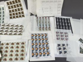A large collection of GB EIIR mint unused commemoratives and definitive, high face value for