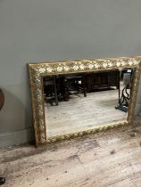 A gilt framed wall mirror, rectangular, the frame moulded with plant forms, 80cm x 110cm