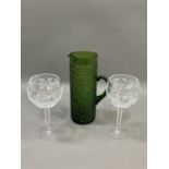 A pair of Waterford cut glass wines on facetted stems, 20cm together with a vintage green glass