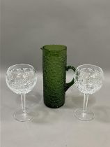 A pair of Waterford cut glass wines on facetted stems, 20cm together with a vintage green glass