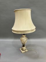 A gilt metal mounted alabaster table lamp of urn form on a square base, complete with shade, 42.