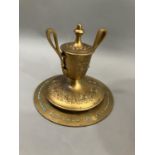 A gilt metal Grand Tour style ink well in the form of an urn with twin loop handles on wide circular