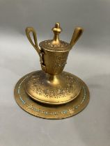 A gilt metal Grand Tour style ink well in the form of an urn with twin loop handles on wide circular