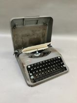 A vintage Hermes portable typewriter in carry case