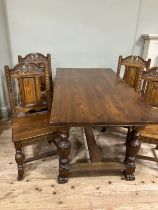 An oak rectangular dining table and set of four chairs with arched back, carved leafage and