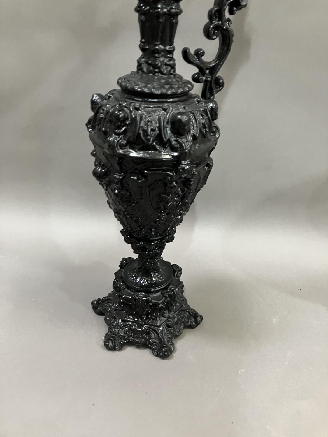 A French black cast metal and heavily moulded ewer, the handle surmounted by cherub, 45cm high - Image 3 of 5