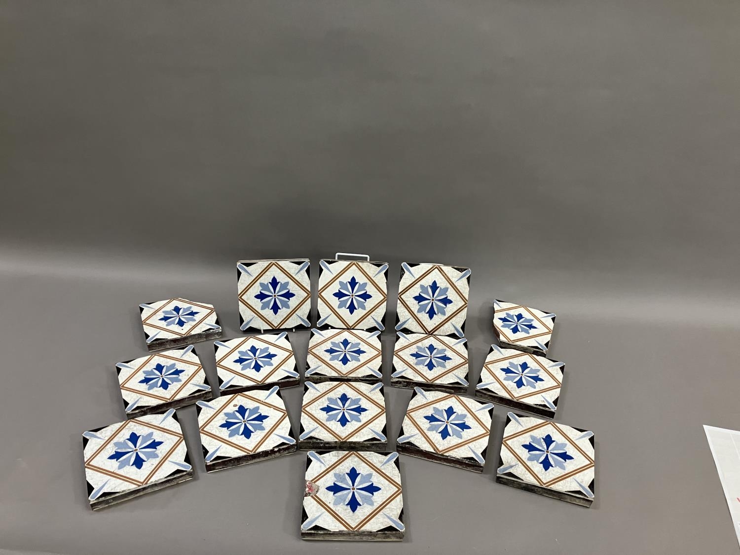 A set of thirteen 19th century Minton tiles glazed in white with a two-shade blue stylised flower to - Image 2 of 3