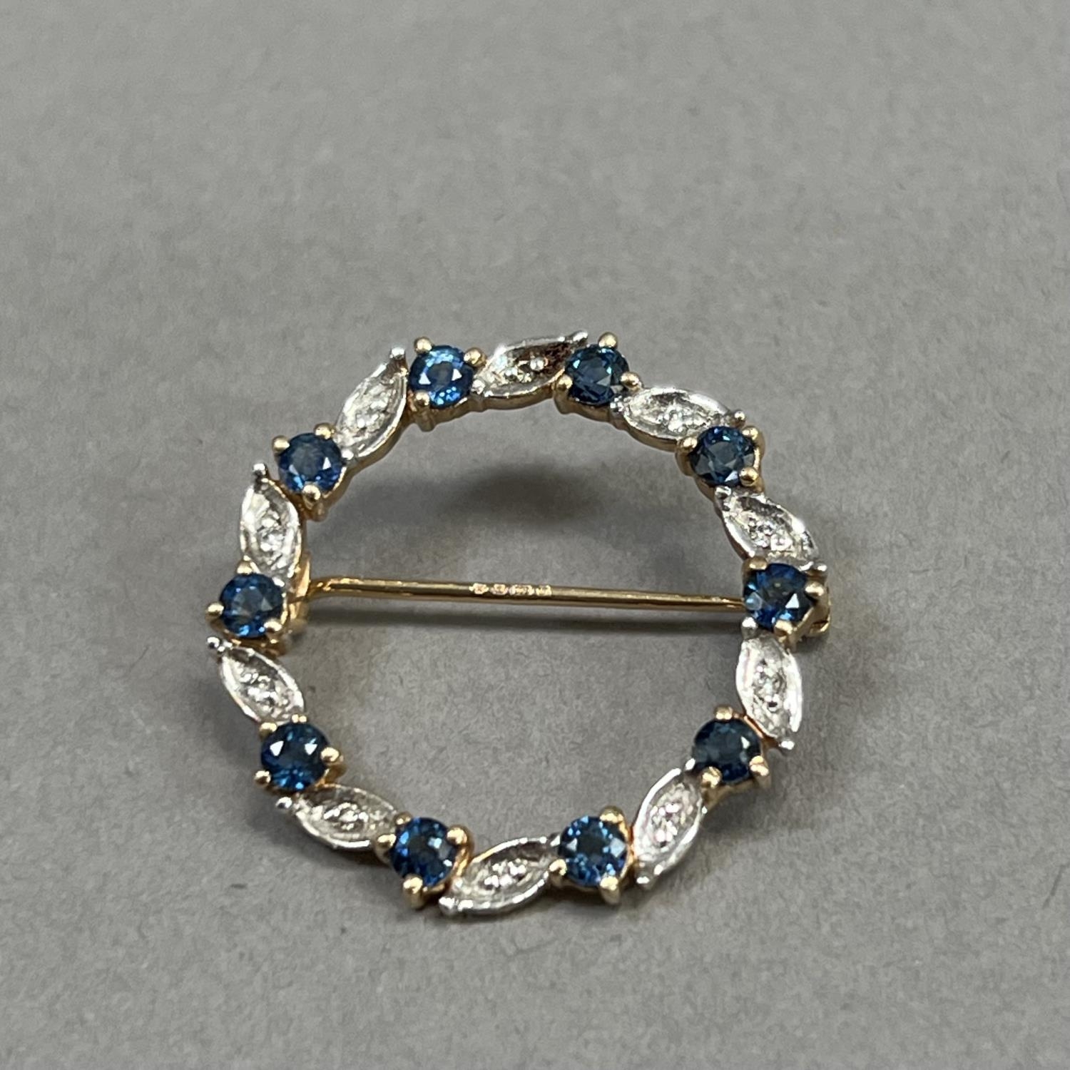 A sapphire and diamond wreath brooch in 9ct gold claw and grain set with small eight cut diamonds - Image 3 of 3