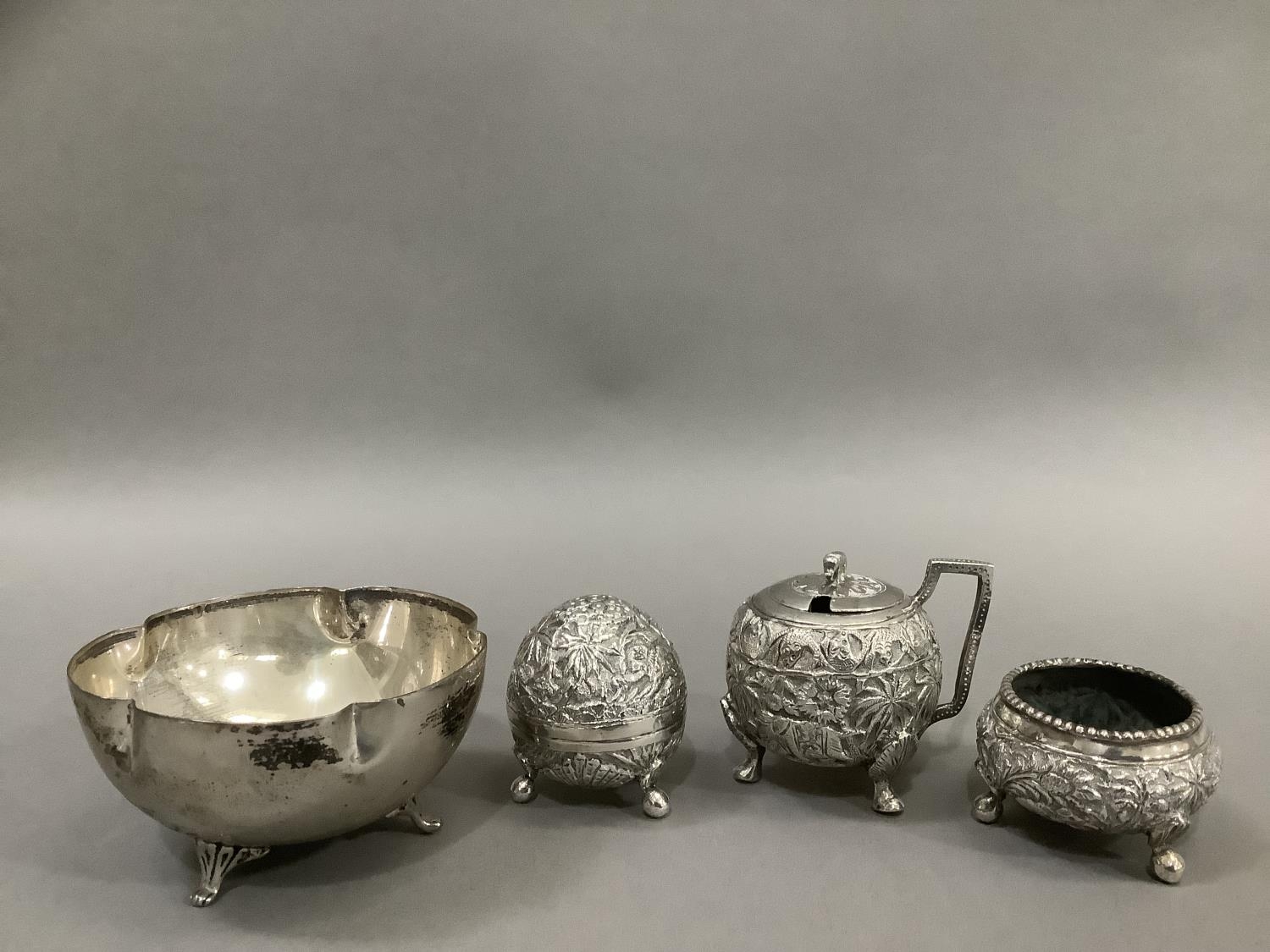 An Indian three piece cruet in white metal (tests as silver) comprising mustard pot, open salt and