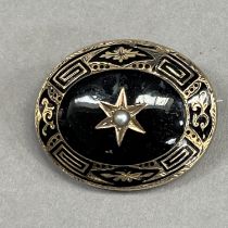 A Victorian morning brooch, stone set to the centre of an oval, jet cabochon A/F with a seed pearl
