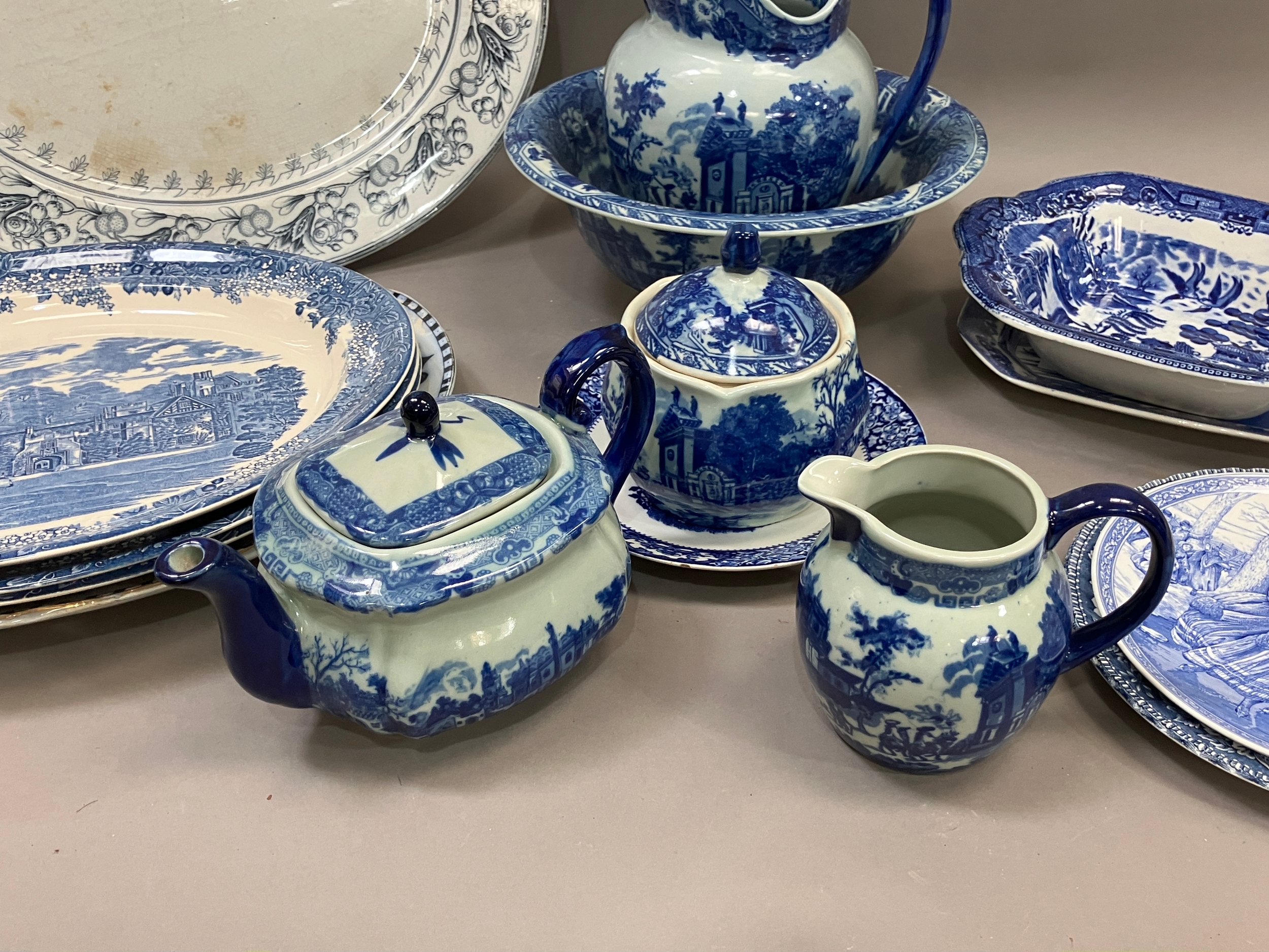 A collection of blue and white ware including jugs, large bowls etc