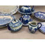 A collection of blue and white ware including jugs, large bowls etc