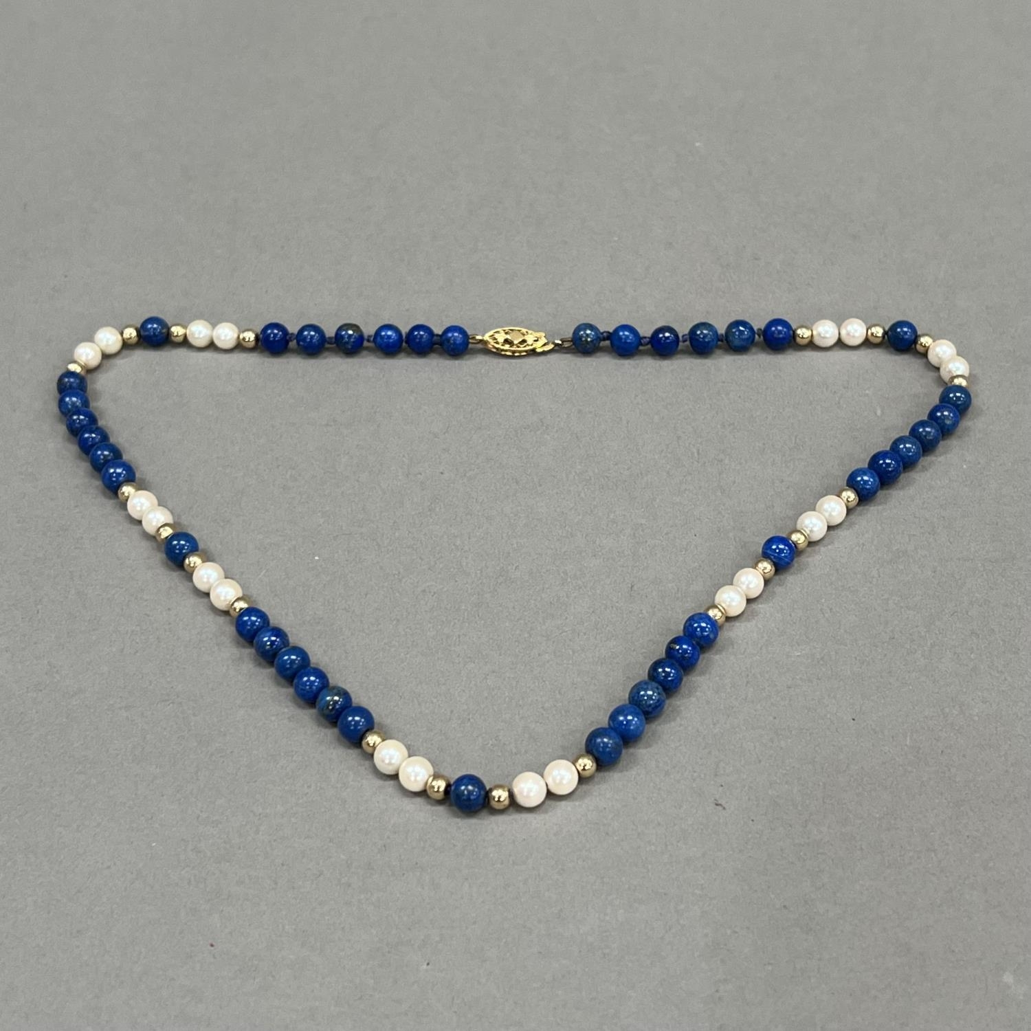 A necklace of spherical 6mm diameter Lapis Lazuli beads, 5.5mm diameter cultured pearls and 4mm