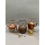 Three copper and brass kettles, two brass trivets together with further brass ware