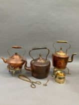 Three copper and brass kettles, two brass trivets together with further brass ware