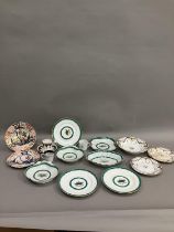 An early to mid century part dessert service bordered in green with green and gilt floral motif to