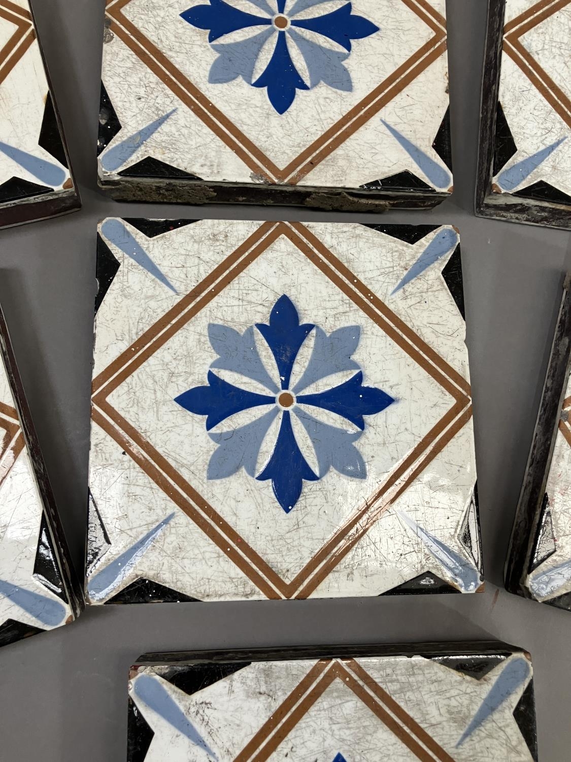 A set of thirteen 19th century Minton tiles glazed in white with a two-shade blue stylised flower to - Image 3 of 3