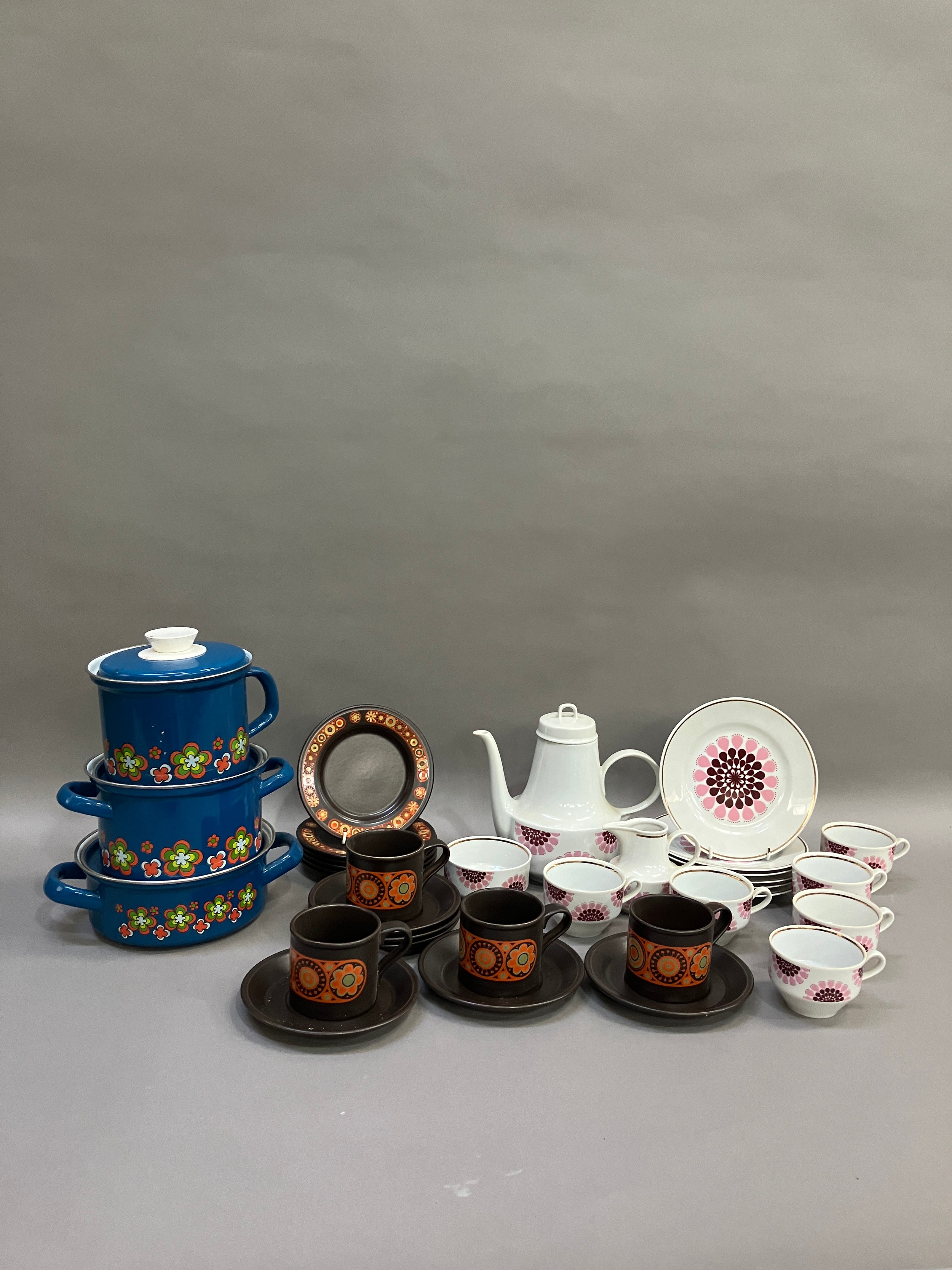 A collection of 1970s items including a pink and white coffee pot cups and tea plate, a brown
