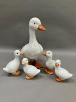 A large ceramic duck together with four others of graduated size