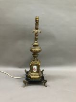 A gilt metal moulded table lamp, the top rim moulded with grape vine, the base having painted