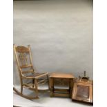 An oak rocking chair with bobbin supports and carved crest together with an oak stool with carved