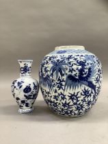 A Chinese ginger jar of ovoid form painted in underglaze blue with opposing pairs of phoenix below a