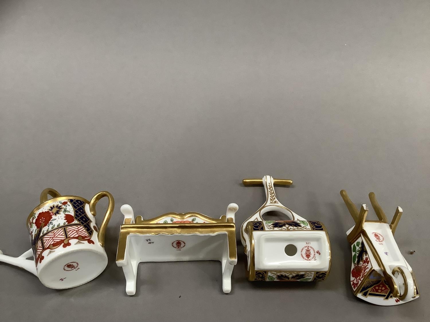 Four Royal Crown Derby miniatures including ag garden bench, watering can, wheelbarrow and garden - Image 4 of 4