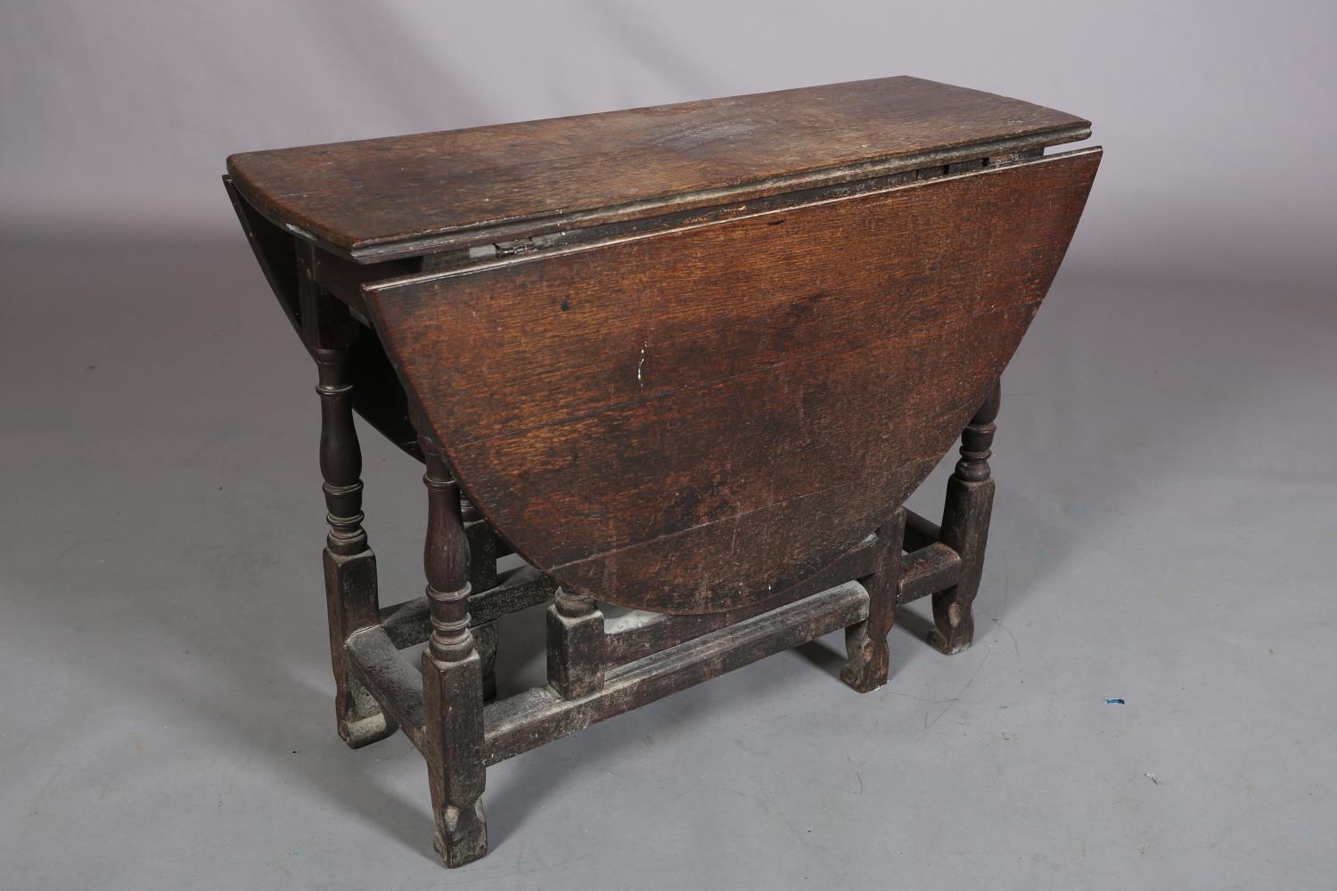 An 18th century oak gateleg supper table having twin oval drop leaves on baluster turned and - Image 2 of 4