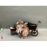 Two modern ceramic dolls with jointed bodies and Victorian style pram together with another