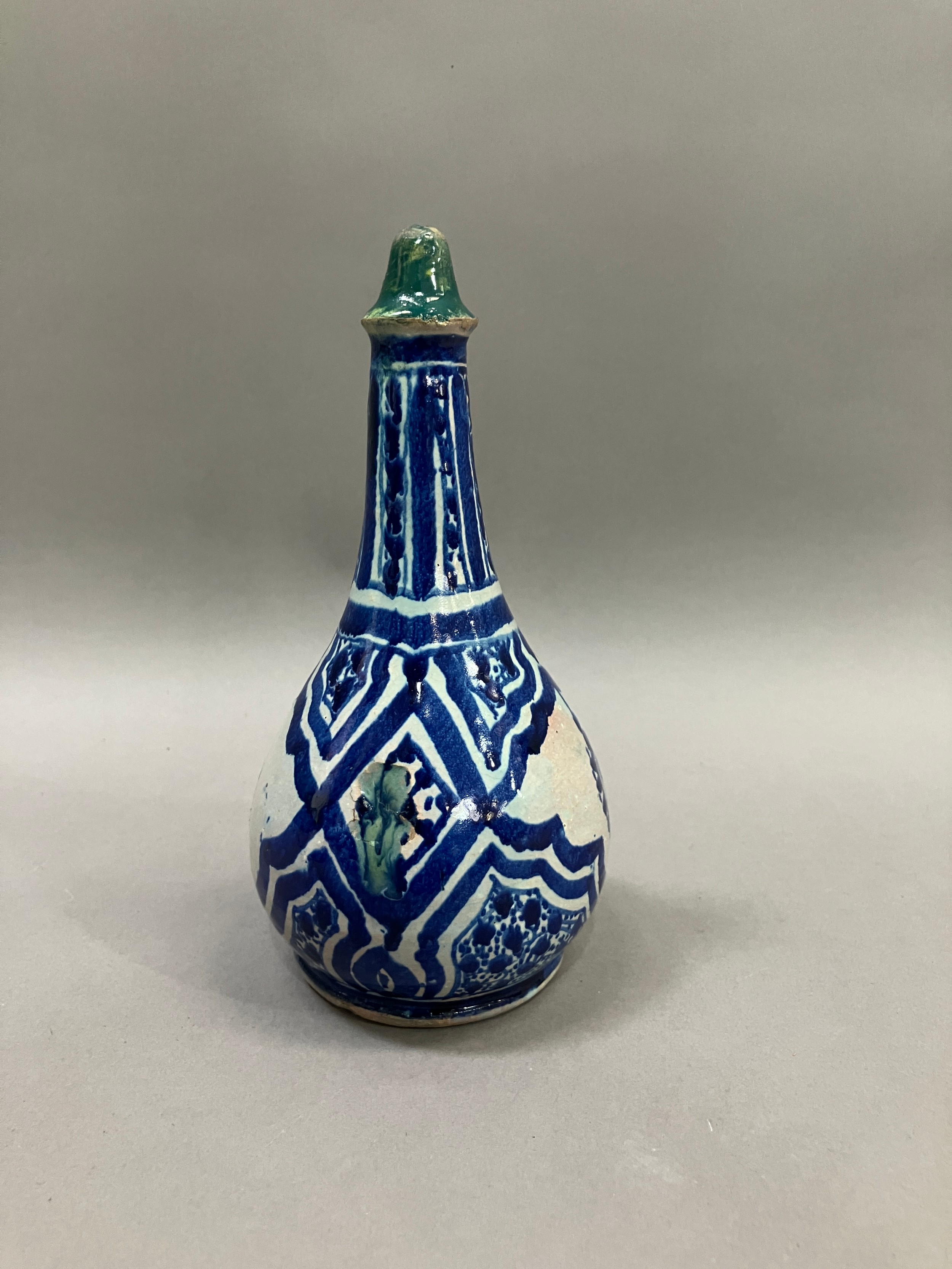 A 19th century Middle Eastern earthenware bottle in grey white and painted in blue with lozenge - Image 2 of 3