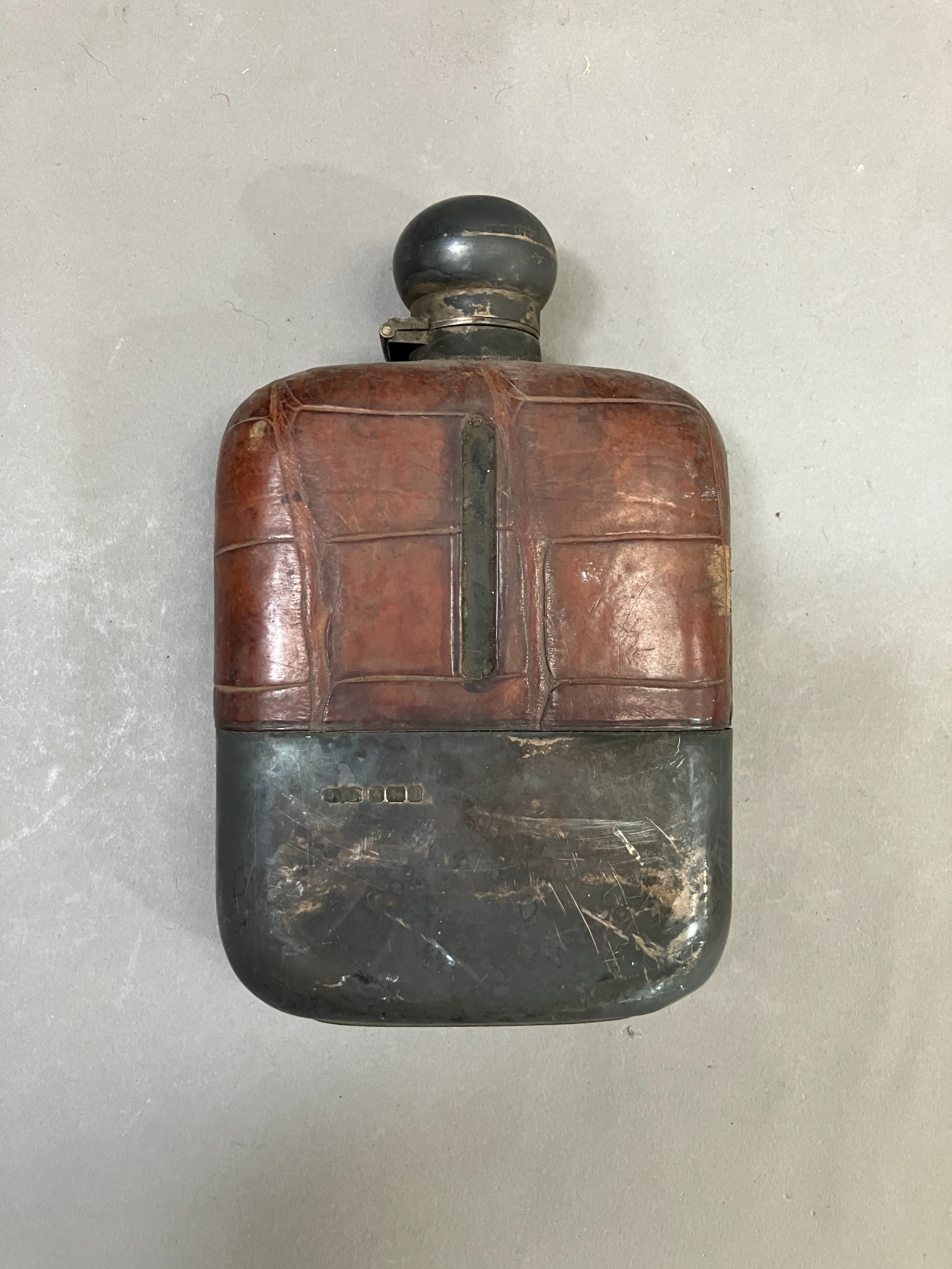 A George V glass hip flask with crocodile leather wrapped top, silver cup and bayonet cap, Sheffield