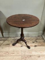 A George III mahogany tripod table having birdcage and vase shaped pedestal, on cabriole legs with