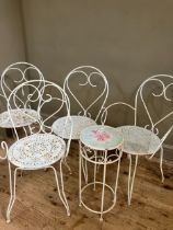 A set of four vintage wire work chairs and a similar table with rose decorated top