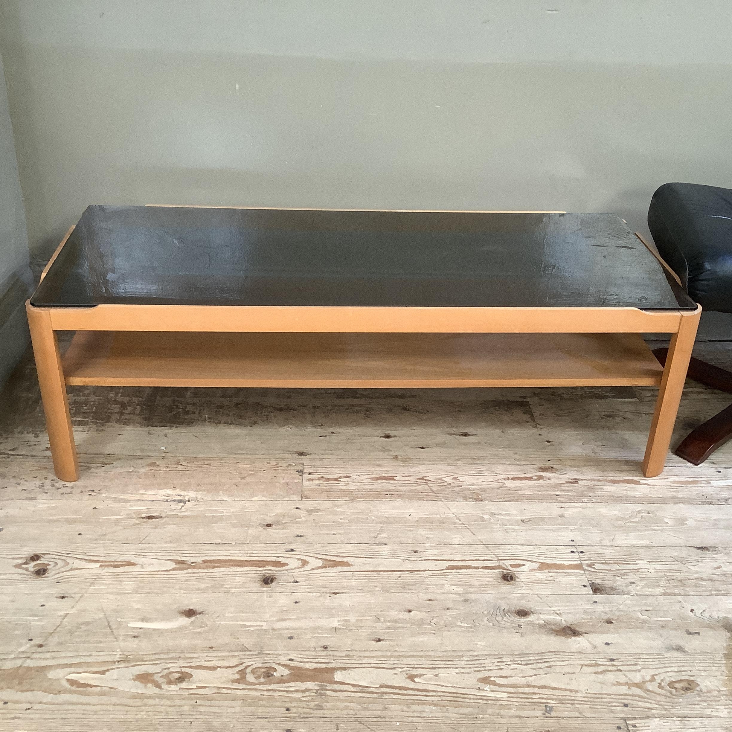 A smoked glass and teak two tier coffee table 112cm x 48cm x 35cm together with a Stressless style - Image 2 of 3