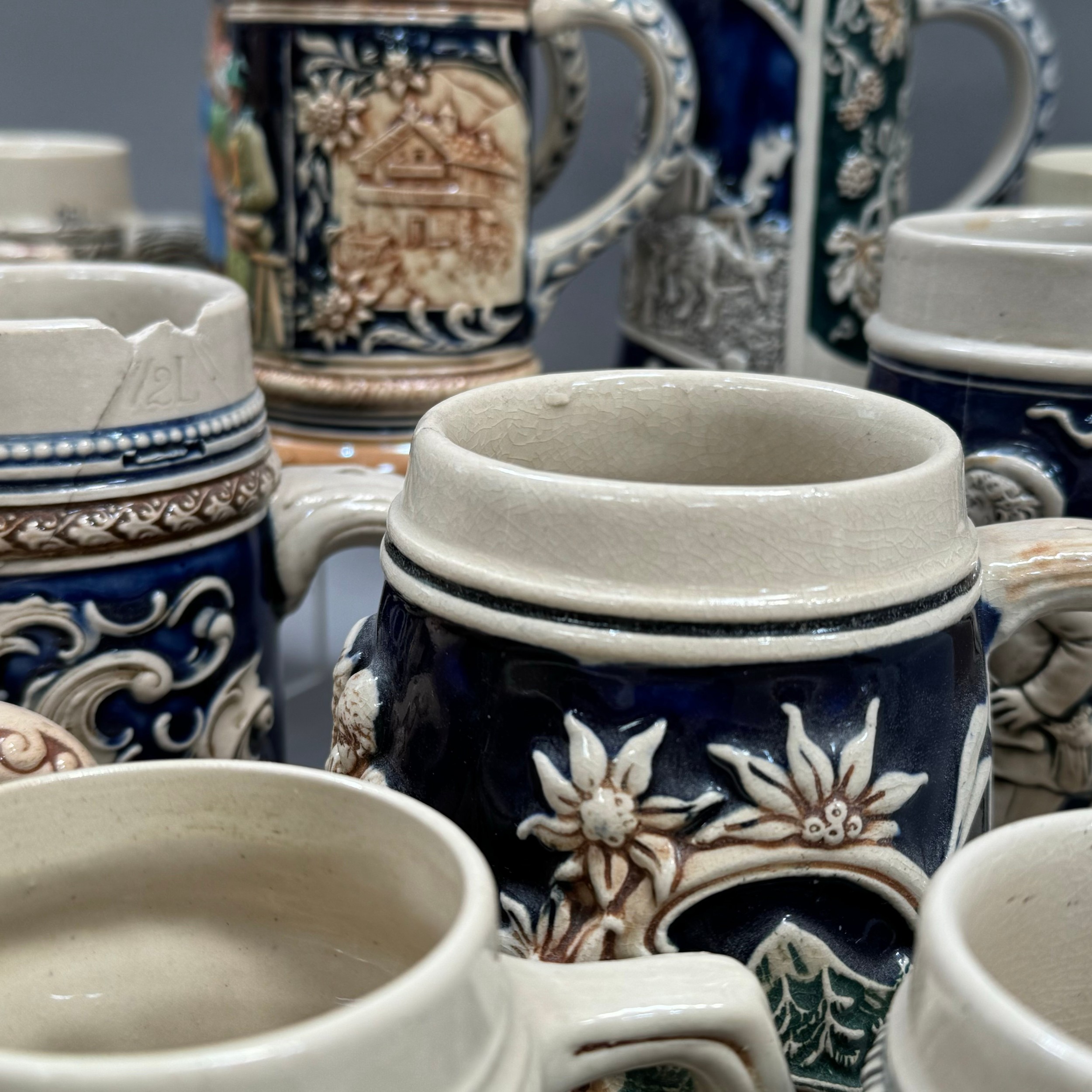 A large quantity of German pottery steins glazed in blue and with relief moulded scenes - Image 2 of 3