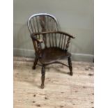 A 19th century low back Windsor armchair, pierced splat and railed back joined by a crinoline