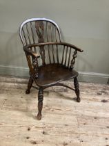 A 19th century low back Windsor armchair, pierced splat and railed back joined by a crinoline