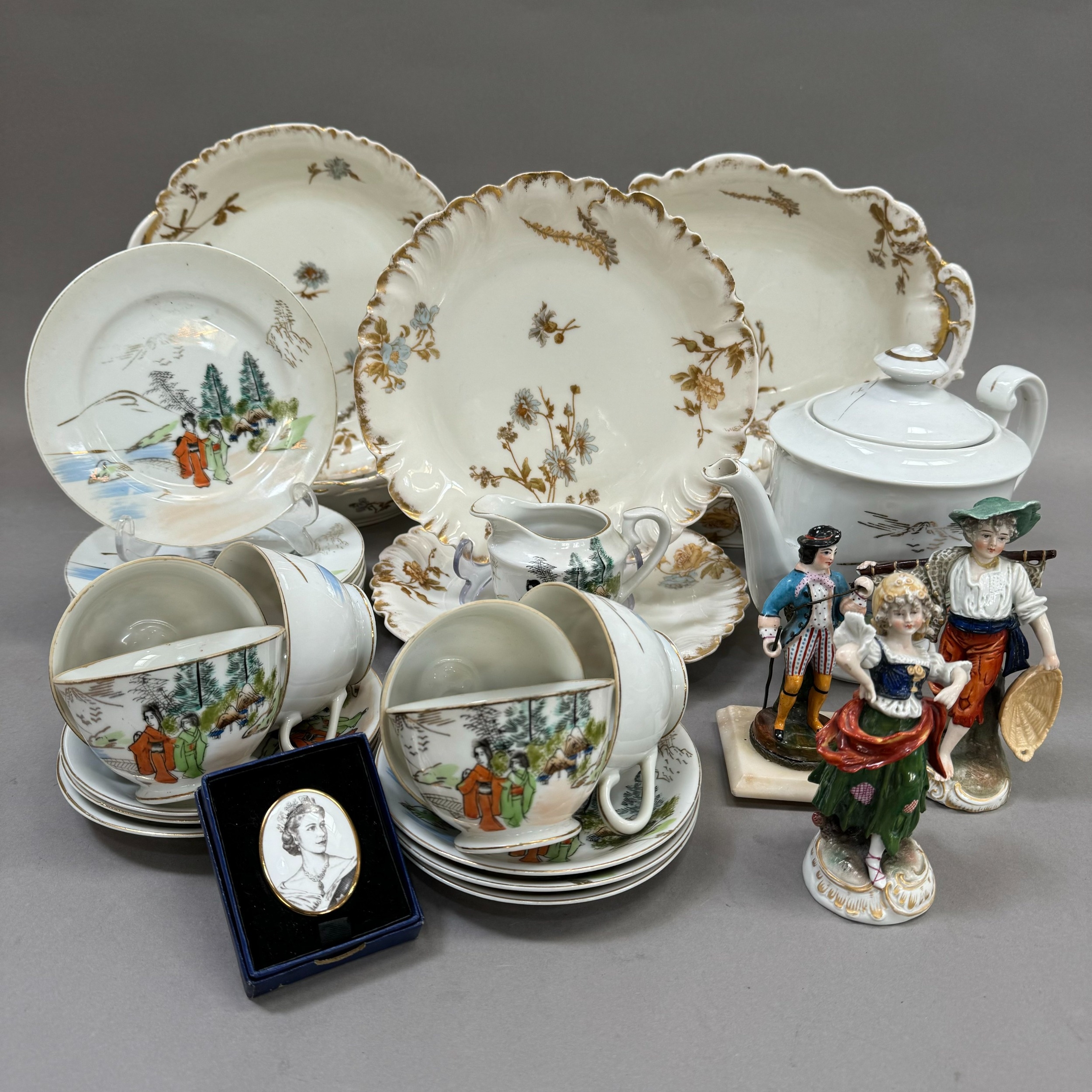 A French china part dessert service comprising two oval serving dishes, two circular ones and two