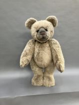 A very large teddy bear by Charlie Bears with pale blonde plush and black eyes, swivel head and