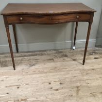 A 19th century mahogany side table of serpentine outline, having a drawer to the frieze with brass