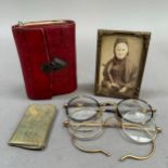 A 19th century leather purse with needle case, notelets and mirror (cracked) with shield shaped