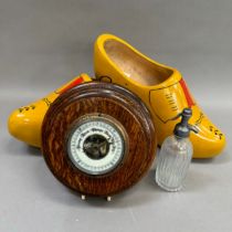 A large pair of wooden clogs painted yellow and red together with a miniature soda syphon and an oak