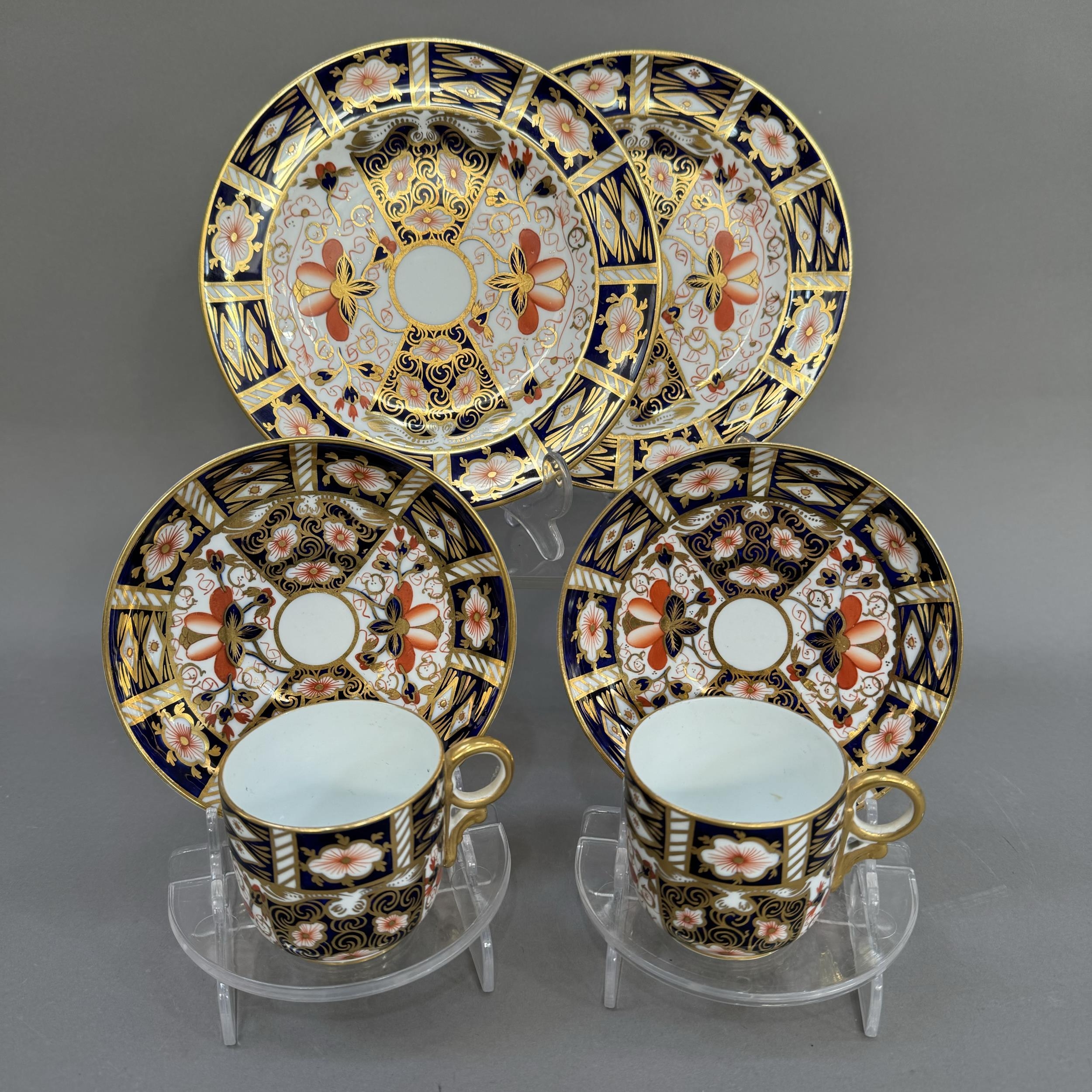 Two Royal Crown Derby trios of cup, saucer and tea plates