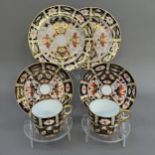 Two Royal Crown Derby trios of cup, saucer and tea plates