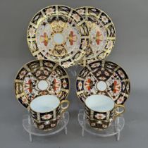 Two Royal Crown Derby trios of cup, saucer and tea plates