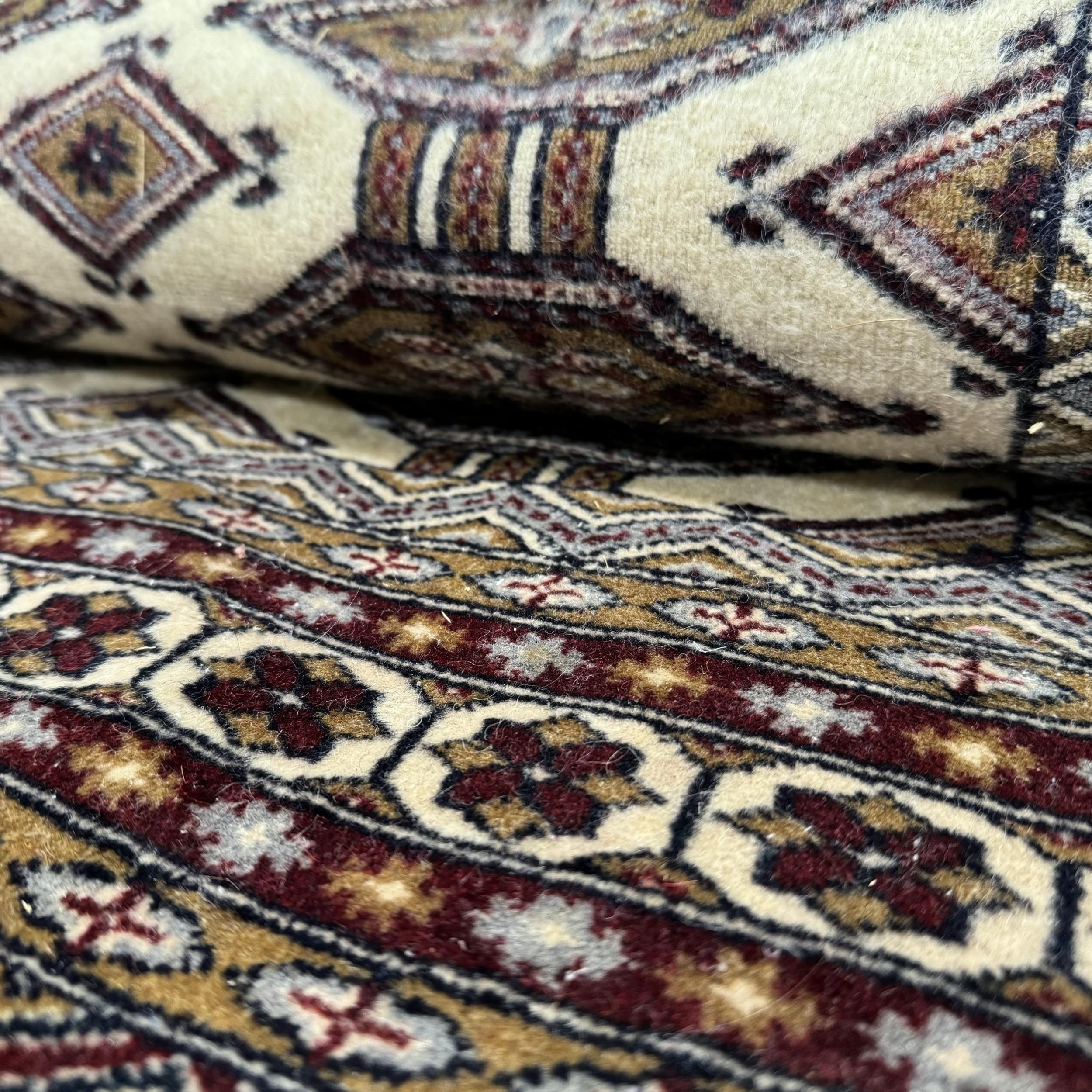 A Caucasian rug, the dark camel ground of conjoined lozenge within multiple borders, colours in dark - Image 2 of 2