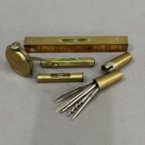 A brass faced wooden 6 inch rule with spirit level together with a brass cased pocket tool kit,