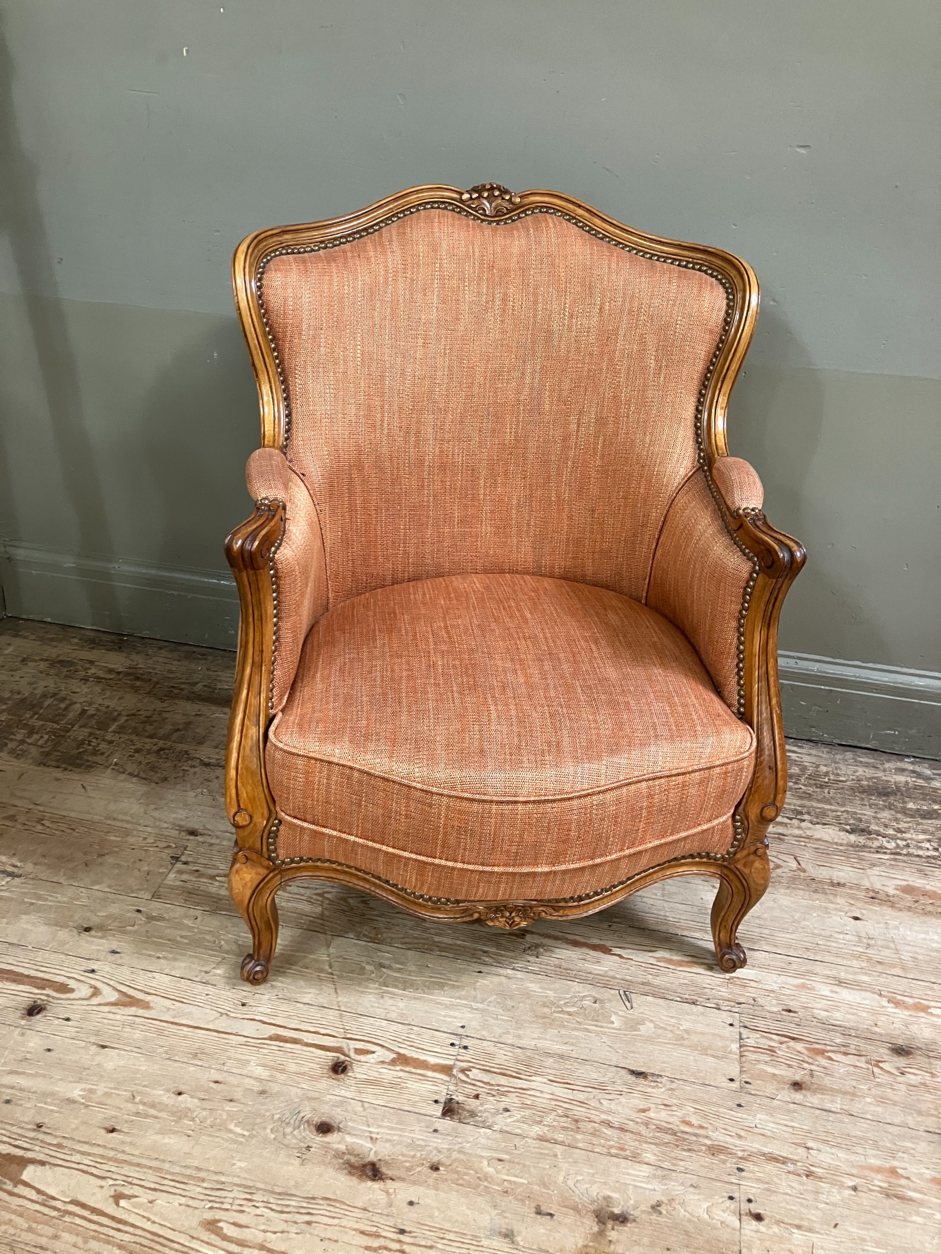 An early 19th century style fruitwood and bergere caned armchair having a square back, upholstered