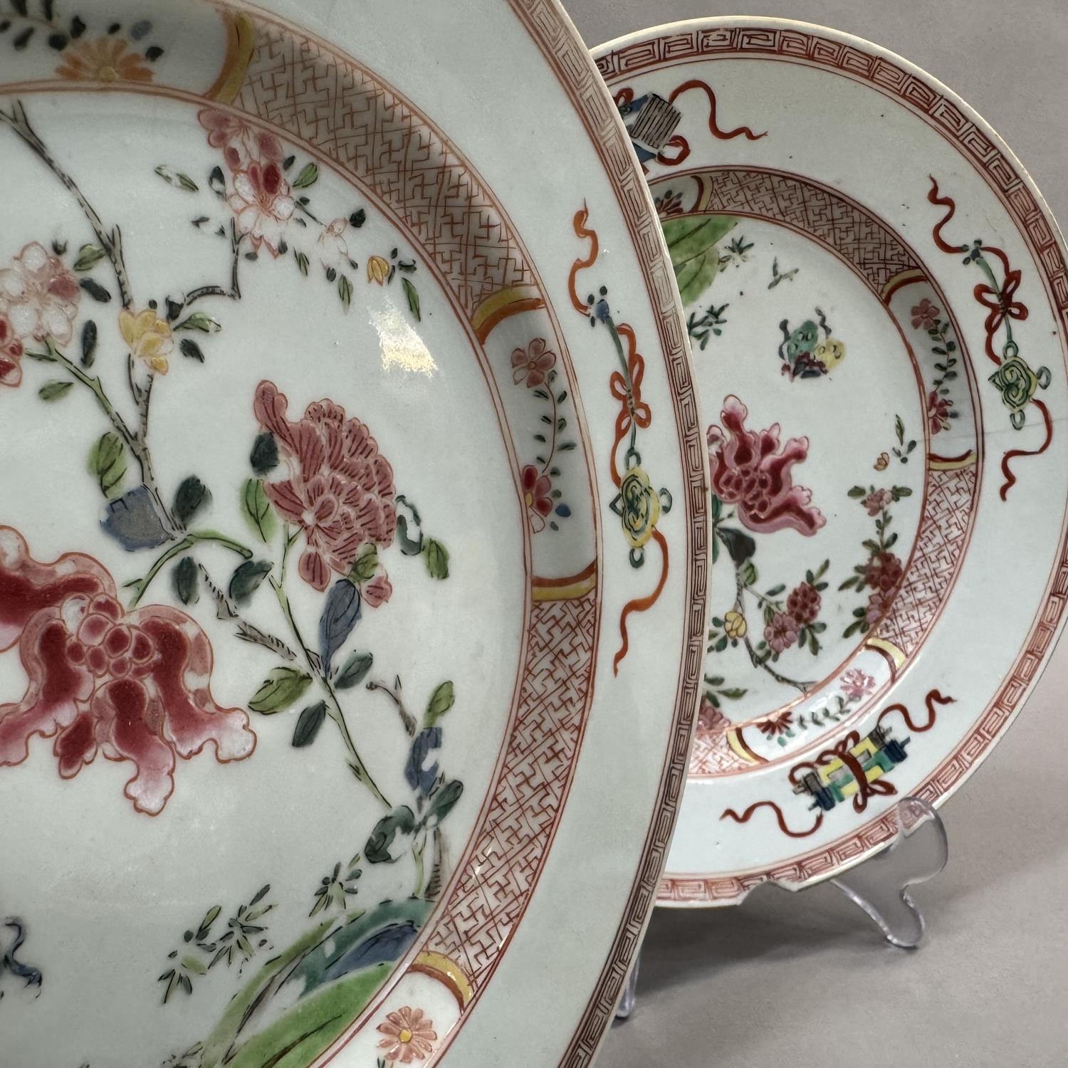 A pair of early 20th century famille rose plates painted to the centre with rocks issuing peony - Image 3 of 9