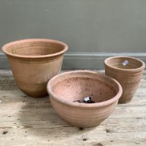 A Yorkshire Flowerpot Company terracotta plant pot, another pot and a further terracotta pot (